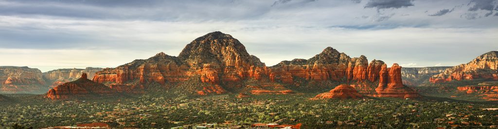 Capitol Butte and Coffee Pot Rock formation panoramic as seen from Airport Mesa over the town of Sedona Arizona USA